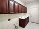 Functional laundry room with ample cabinet space and tile flooring at 2112 Merganser Ct, North Las Vegas, NV 89084