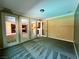 Open living space with French doors leading to other rooms and neutral carpet at 2112 Merganser Ct, North Las Vegas, NV 89084