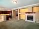 Spacious living room with fireplace and kitchen area at 2112 Merganser Ct, North Las Vegas, NV 89084