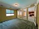 Open concept living room with windows and views of the kitchen through French doors at 2112 Merganser Ct, North Las Vegas, NV 89084