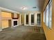 Carpeted living room featuring a fireplace and multiple glass doors at 2112 Merganser Ct, North Las Vegas, NV 89084