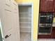 Walk-in pantry with shelving, adjacent to the stainless oven and kitchen area at 2112 Merganser Ct, North Las Vegas, NV 89084