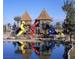 Reflection of the community playground with towers and spiraling slides on the surface of a calm pond at 2112 Merganser Ct, North Las Vegas, NV 89084