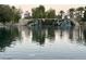 A tranquil pond with water cascading down a decorative rock waterfall feature, a relaxing view at 2112 Merganser Ct, North Las Vegas, NV 89084