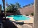 Private backyard pool with rock features and tropical landscaping, creating a serene oasis at 2112 Merganser Ct, North Las Vegas, NV 89084