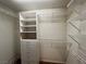 Spacious walk-in closet offers an abundance of metal shelves and a white storage unit at 2112 Merganser Ct, North Las Vegas, NV 89084