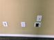 Electrical outlets and speaker connections on a neutral painted wall with carpet trim at 2112 Merganser Ct, North Las Vegas, NV 89084