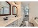 Bright primary bathroom features double sink vanity, soaking tub, walk-in shower, and neutral decor at 2470 Lower Meadows Ave, Henderson, NV 89052