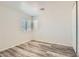 Cozy bedroom with wood-look flooring, neutral walls, a large window, and ample closet space at 2470 Lower Meadows Ave, Henderson, NV 89052