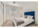 Bedroom features plush carpet, a large window, closet and a stylish tufted blue headboard at 2470 Lower Meadows Ave, Henderson, NV 89052