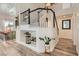 Grand entryway featuring a staircase, an alcove with decor, and seamless transition into the kitchen and dining area at 2470 Lower Meadows Ave, Henderson, NV 89052