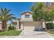 Charming home featuring a well-maintained lawn, desert landscaping, and a two-car garage at 2470 Lower Meadows Ave, Henderson, NV 89052