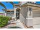 Beautiful home showcasing desert landscaping, arched entryway, and textured stucco walls at 2470 Lower Meadows Ave, Henderson, NV 89052