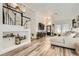 Open concept living area featuring a staircase, modern decor, and wood-look flooring at 2470 Lower Meadows Ave, Henderson, NV 89052