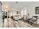 Inviting living space with lots of light, a large sectional, modern decor, and wood flooring at 2470 Lower Meadows Ave, Henderson, NV 89052