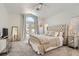 Bright bedroom with elegant furnishings including a tufted headboard, mirrored nightstands, and patio access at 2470 Lower Meadows Ave, Henderson, NV 89052