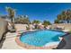 Backyard pool and spa with waterfall feature surrounded by lush landscaping at 2470 Lower Meadows Ave, Henderson, NV 89052