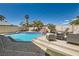 Backyard pool with waterfall feature, sun-loungers and seating areas at 2470 Lower Meadows Ave, Henderson, NV 89052