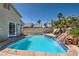 Backyard pool with lush landscaping, waterfall, patio and attached spa at 2470 Lower Meadows Ave, Henderson, NV 89052