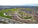 A high-angle perspective of a meticulously landscaped community park with meandering walking trails at 253 Kindly Way, Henderson, NV 89011