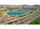 Aerial view of a beautiful community park with a serene lake and pedestrian walkways at 253 Kindly Way, Henderson, NV 89011