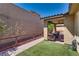 Relax in this tranquil outdoor space with artificial turf and covered patio at 253 Kindly Way, Henderson, NV 89011