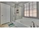 Bathroom with a soaking tub, glass enclosed shower and window at 253 Kindly Way, Henderson, NV 89011