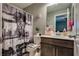 Charming full bathroom features framed mirror, vanity and decorative shower curtain at 253 Kindly Way, Henderson, NV 89011