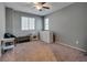 Bedroom with light walls, ceiling fan, two windows and carpet at 253 Kindly Way, Henderson, NV 89011