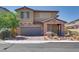 Charming two-story home featuring a stone facade, two car garage, and low maintenance desert landscaping at 253 Kindly Way, Henderson, NV 89011