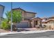 Charming two-story home featuring a stone facade, two car garage, and low maintenance desert landscaping at 253 Kindly Way, Henderson, NV 89011