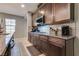 Kitchen features granite countertops, dark wood cabinets and stainless appliances at 253 Kindly Way, Henderson, NV 89011