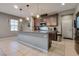 Well-lit kitchen boasts a large island with granite countertops and modern stainless steel appliances at 253 Kindly Way, Henderson, NV 89011