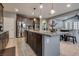 Spacious kitchen with stainless steel appliances, pendant lighting and an adjacent dining area at 253 Kindly Way, Henderson, NV 89011