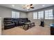 Living room with an oversized reclining sofa, ceiling fan, and carpet at 253 Kindly Way, Henderson, NV 89011
