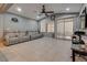 Living room with comfortable seating, ceiling fan, and large windows for natural light at 253 Kindly Way, Henderson, NV 89011