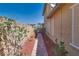 Paver walkway between homes surrounded by tasteful desert landscaping at 253 Kindly Way, Henderson, NV 89011