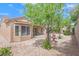 Charming backyard with a decorative water fountain, patio, and mature trees at 2573 Grandville Ave, Henderson, NV 89052