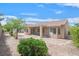 Private backyard offers a tranquil retreat with desert landscaping and mature trees at 2573 Grandville Ave, Henderson, NV 89052