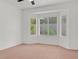 Bright bedroom featuring a bay window, neutral carpet and paint, and a ceiling fan at 2573 Grandville Ave, Henderson, NV 89052