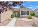 Close-up of the home's front yard, showcasing the desert landscaping, mature trees, and covered entrance at 2573 Grandville Ave, Henderson, NV 89052
