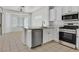Modern kitchen with stainless steel appliances, white cabinets, and a breakfast nook with lots of natural light at 2573 Grandville Ave, Henderson, NV 89052