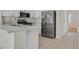 Modern kitchen featuring stainless steel appliances, white cabinetry, and a breakfast bar for casual dining at 2573 Grandville Ave, Henderson, NV 89052