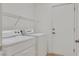 Clean and bright laundry area features a modern washer and dryer and ample shelving at 2573 Grandville Ave, Henderson, NV 89052