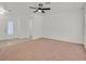Spacious living room with neutral carpet flooring and a ceiling fan, perfect for relaxing or entertaining guests at 2573 Grandville Ave, Henderson, NV 89052