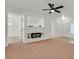Bright and open-concept living room with white walls, neutral carpet, and a modern fireplace feature at 2573 Grandville Ave, Henderson, NV 89052