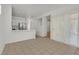 Open-concept living space with tile flooring that connects to the kitchen, and a sliding glass door to the backyard at 2573 Grandville Ave, Henderson, NV 89052