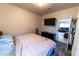 This bedroom features a large flat screen tv and is located near other living areas at 2612 Sonora St, Las Vegas, NV 89102