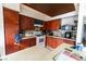 Kitchen area showcases wood cabinets, white appliances, and stone-look backsplash at 2612 Sonora St, Las Vegas, NV 89102