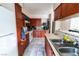 View of the kitchen featuring wood cabinetry, tile floors, and white appliances at 2612 Sonora St, Las Vegas, NV 89102
